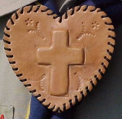 Embossed cross on heart